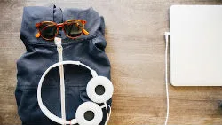 Backpack with sunglasses, headphones and laptop