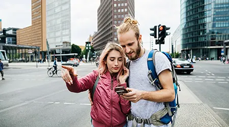 Young travelling couple on a phone