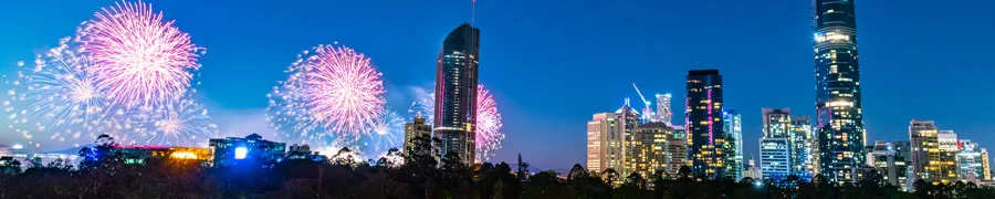 Australia Day fireworks go off against the Brisbane skyline as viewed from Kangaroo Point Cliffs Park.