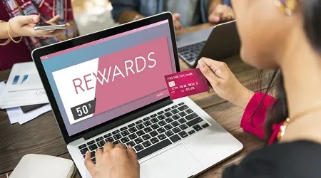 rewards credit card woman computer shopping