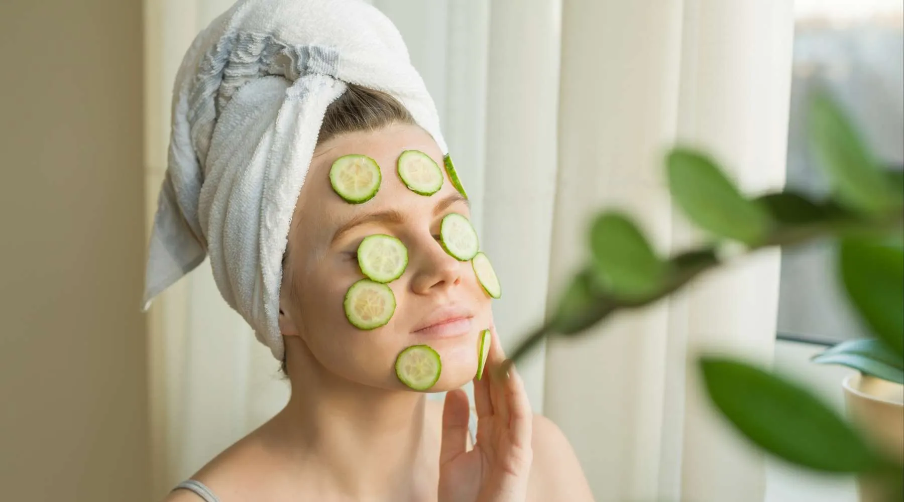 Woman in spa covered in cucumbers