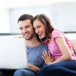 smiling couple with laptop