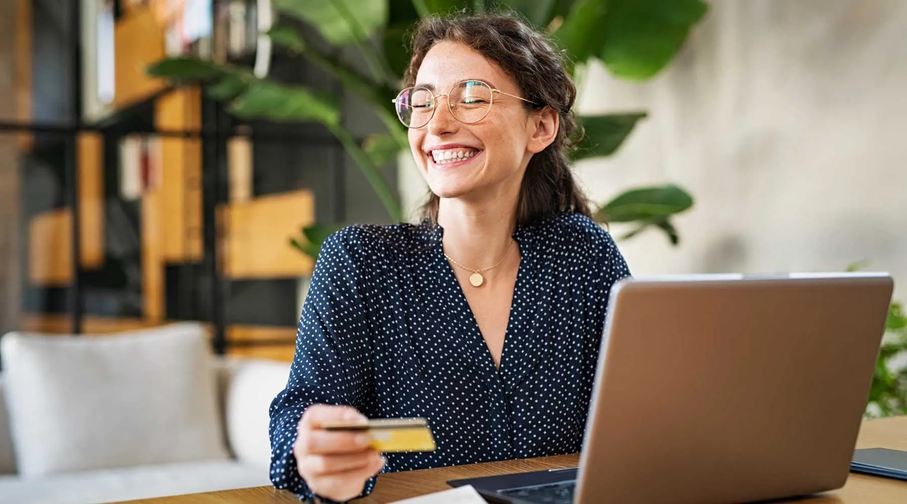 A smiling woman paying for health insurance