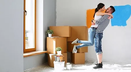 Couple hugging while painting room