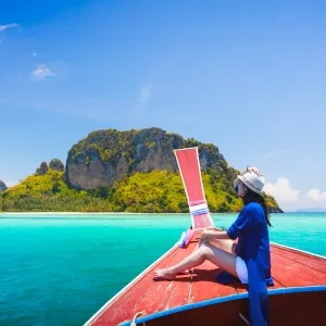 Happy female traveling on boat, Krabi Thailand