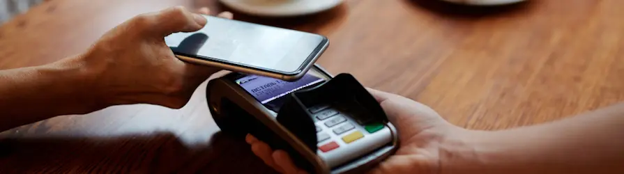 phone hovering on credit card terminal