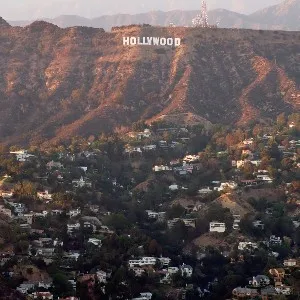 View of the Hollywood sign above suburban houses in Los Angeles.