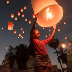 Women release Khom Loi, the sky lanterns during Yi Peng or Loi Krathong festival in Chiang Mai, Thailand.