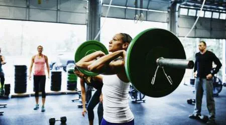 Woman preparing to press barbell overhead