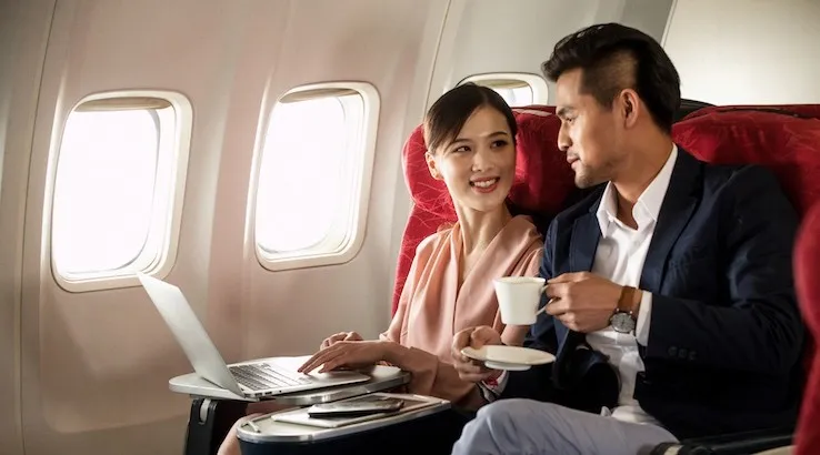 A man and woman flying in business class. Image: Getty Images