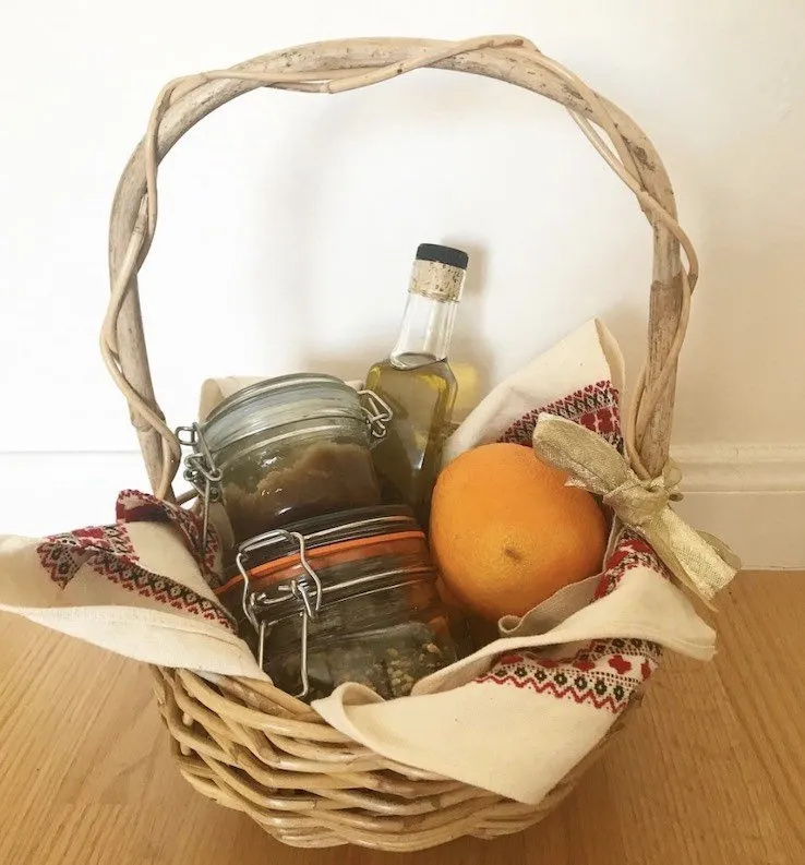A #DIYDecember gift hamper with fruit, oil and reusable jars of consumable products.