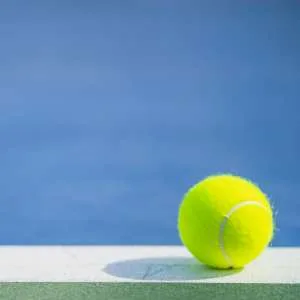 one new tennis ball on white line in blue and green hard court with light from right, shadow and copy space on left (one new tennis ball on white line in blue and green hard court with light from right, shadow and copy space on left, ASCII, 116 compon