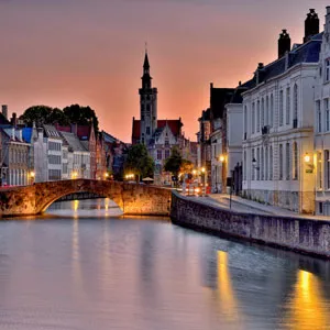 Dusk in Bruges, Belgium. A view of Spiegelrei seen from the Spinolarei street. In the background the Poortersloge.