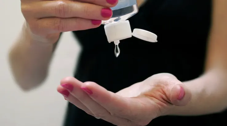 Woman Applying Hand Sanitizer