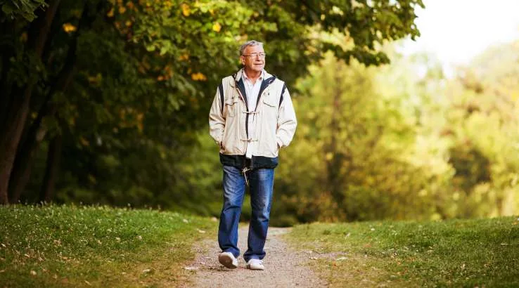Older man walking in park