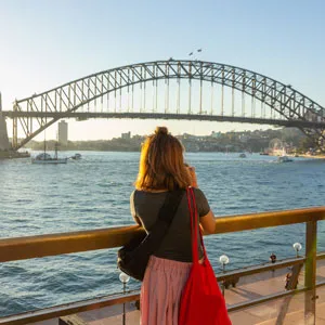 Rear View Of Woman Looking At Sydney Harbor Bridge Over River Against Sky