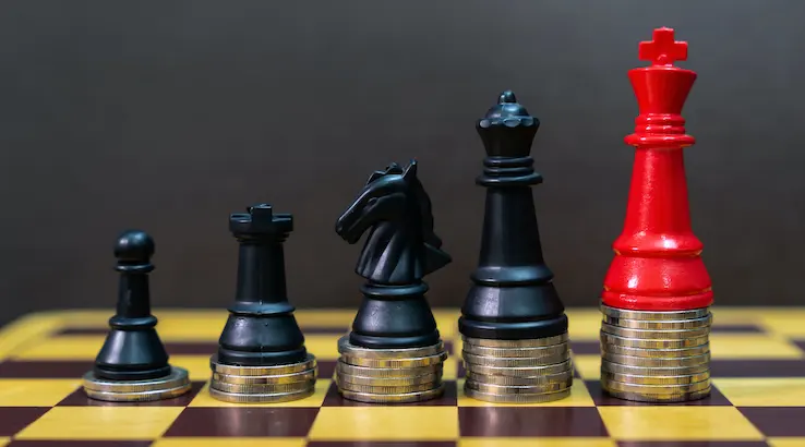 Chess and coins in concept of money power or saving money, business finance wealth and success, financial growth.