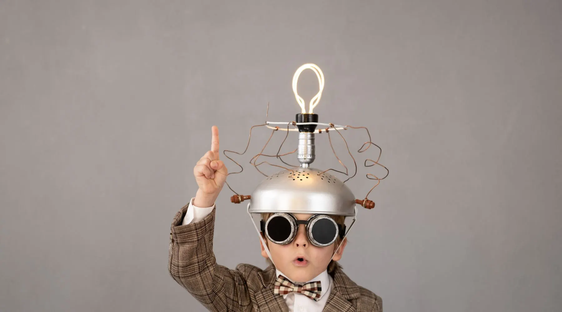 Smart Child Wearing Funny Helmet with Illuminated Lightbulb