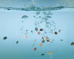 Coins falling in water.
