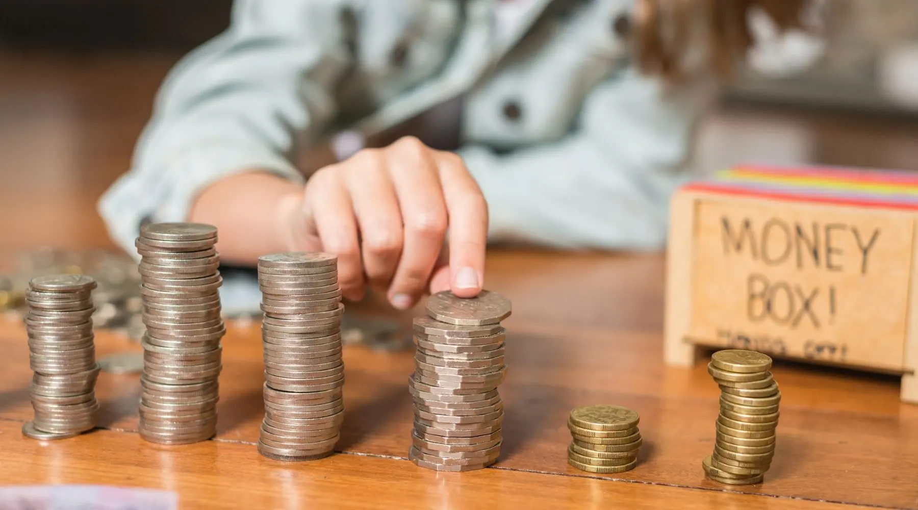 A child counts Australian coins.