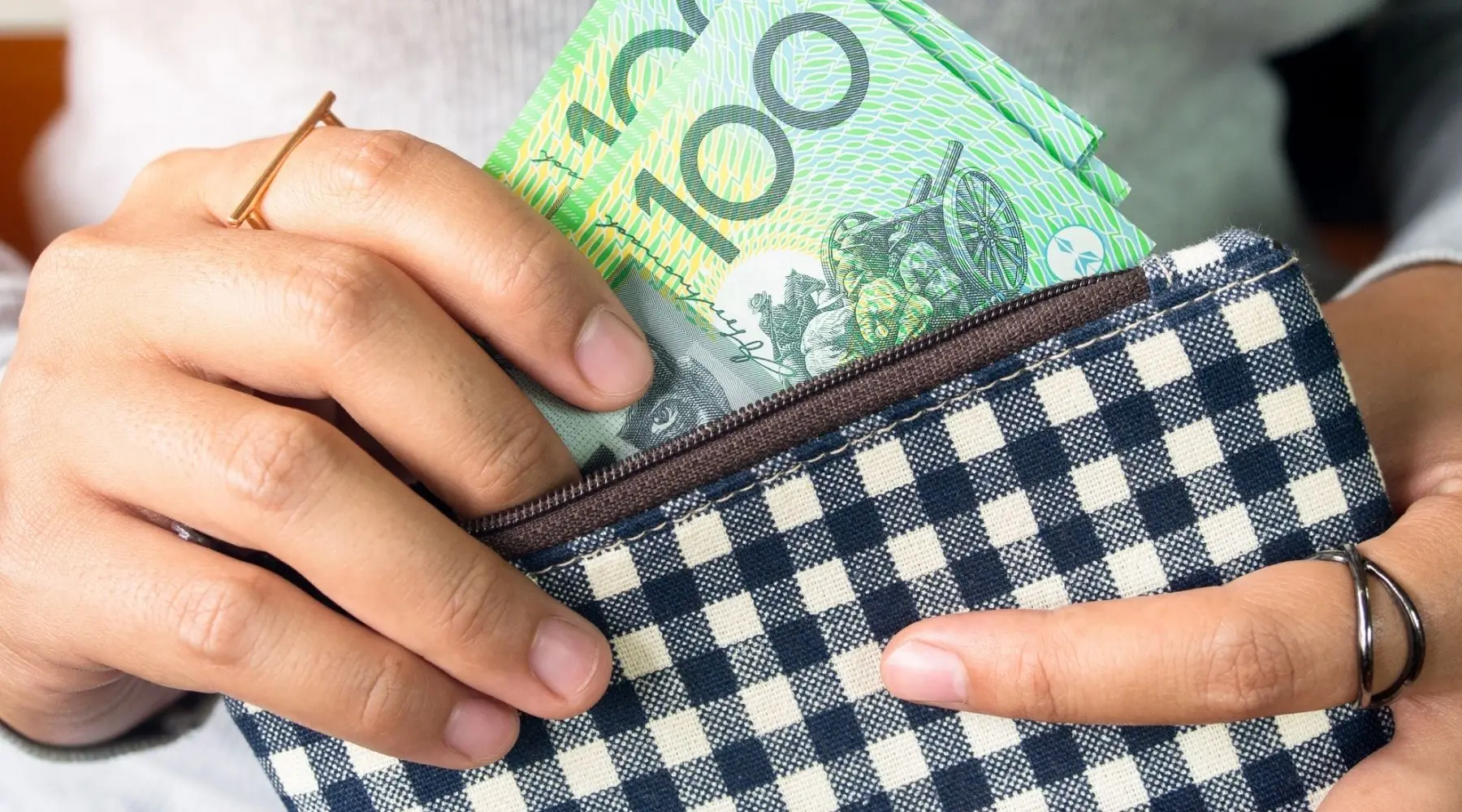 A woman holding Australian cash.