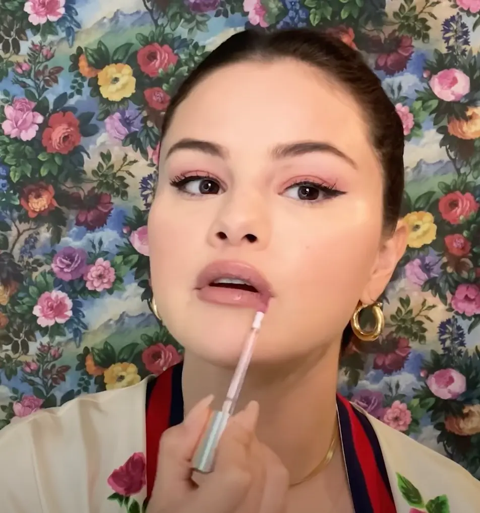 Selena Gomez applying the Rare Beauty Lip Souffle Matte Cream Lipstick. 