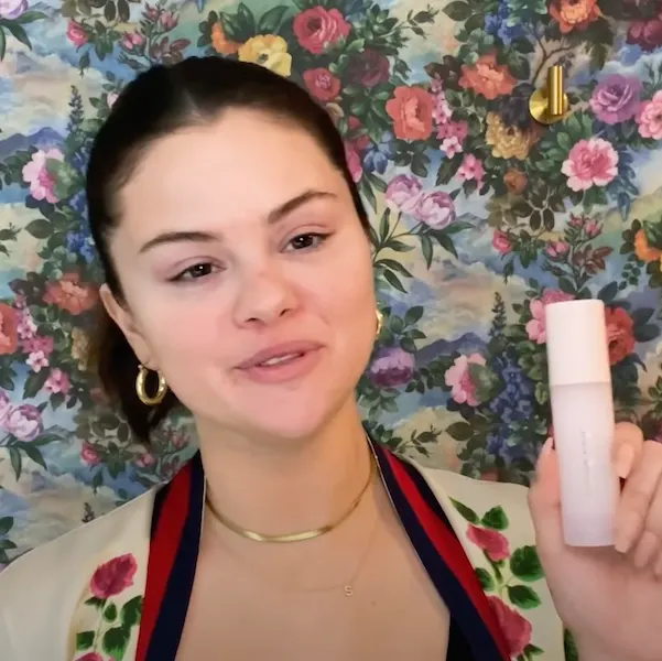 Selena Gomez holding the Rare Beauty primer.