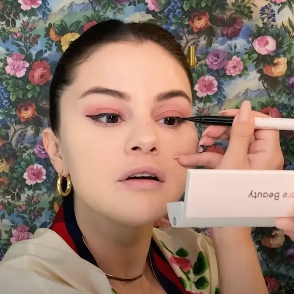 Selena Gomez applying the Rare Beauty liquid eyeliner.