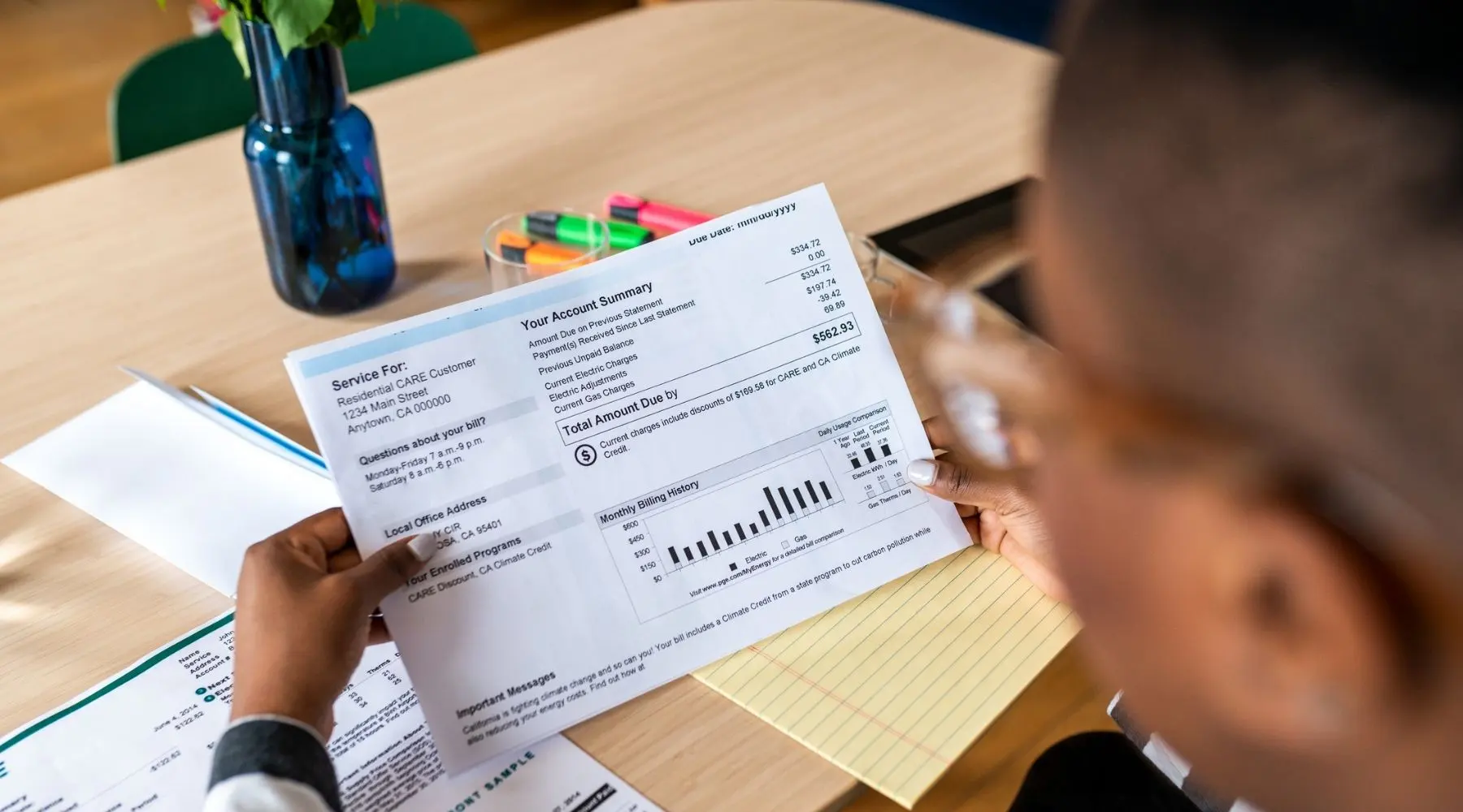 A young woman looks at an electricity bill.