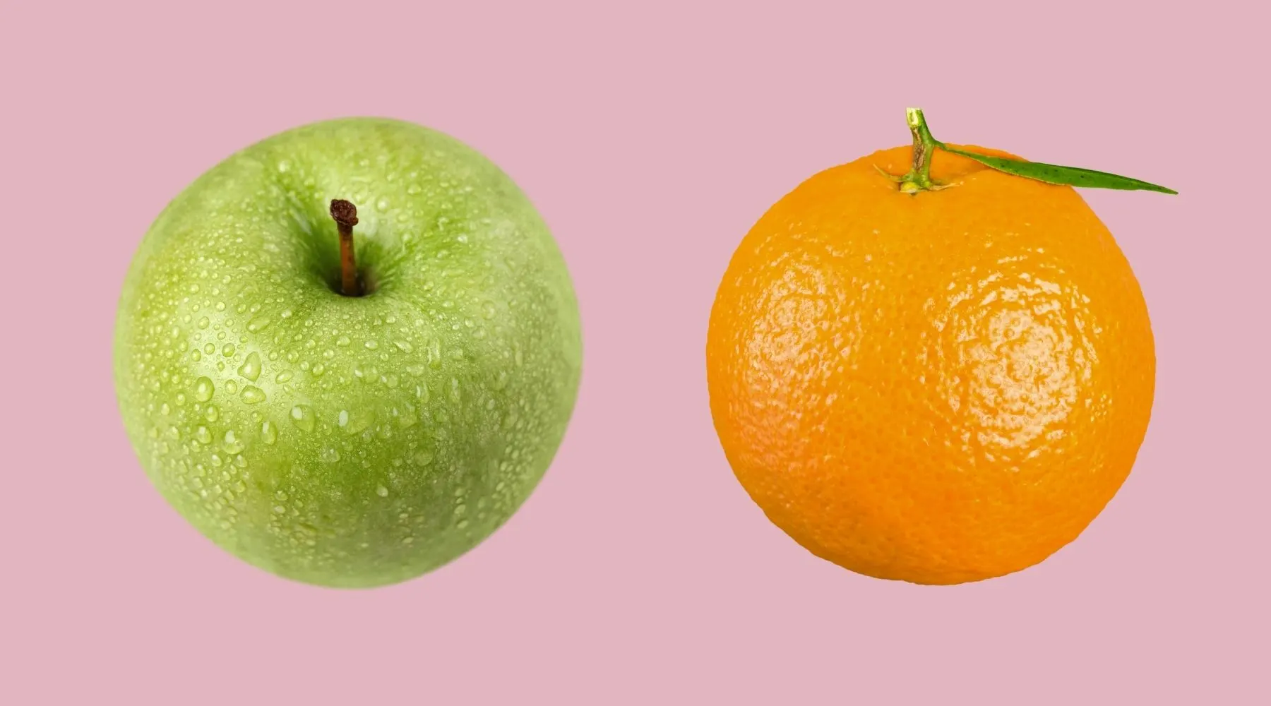 An apple and an orange on a pink background.