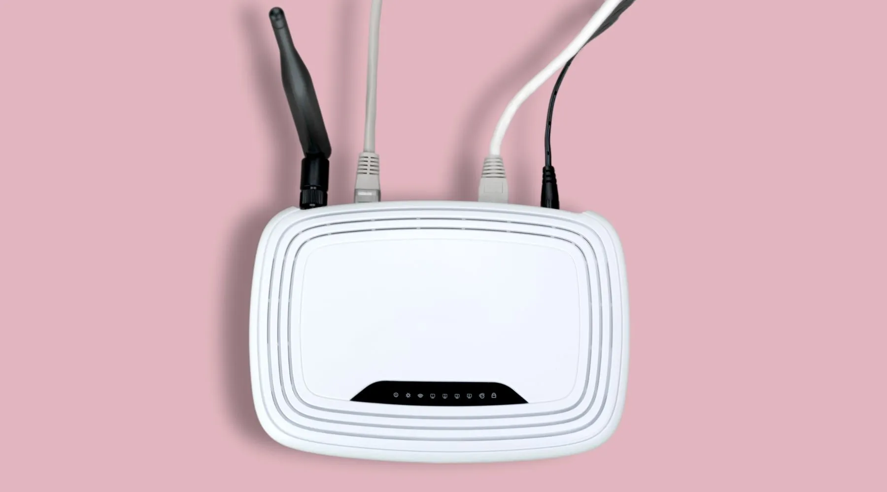 A white modem on a pink background.