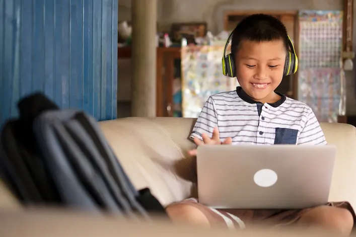 Photo of kid using a laptop