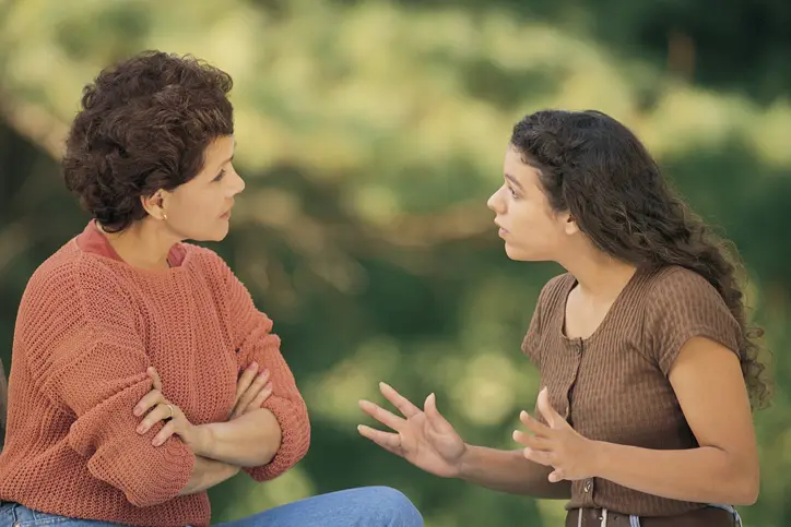 Mother and daughter arguing outdoors
