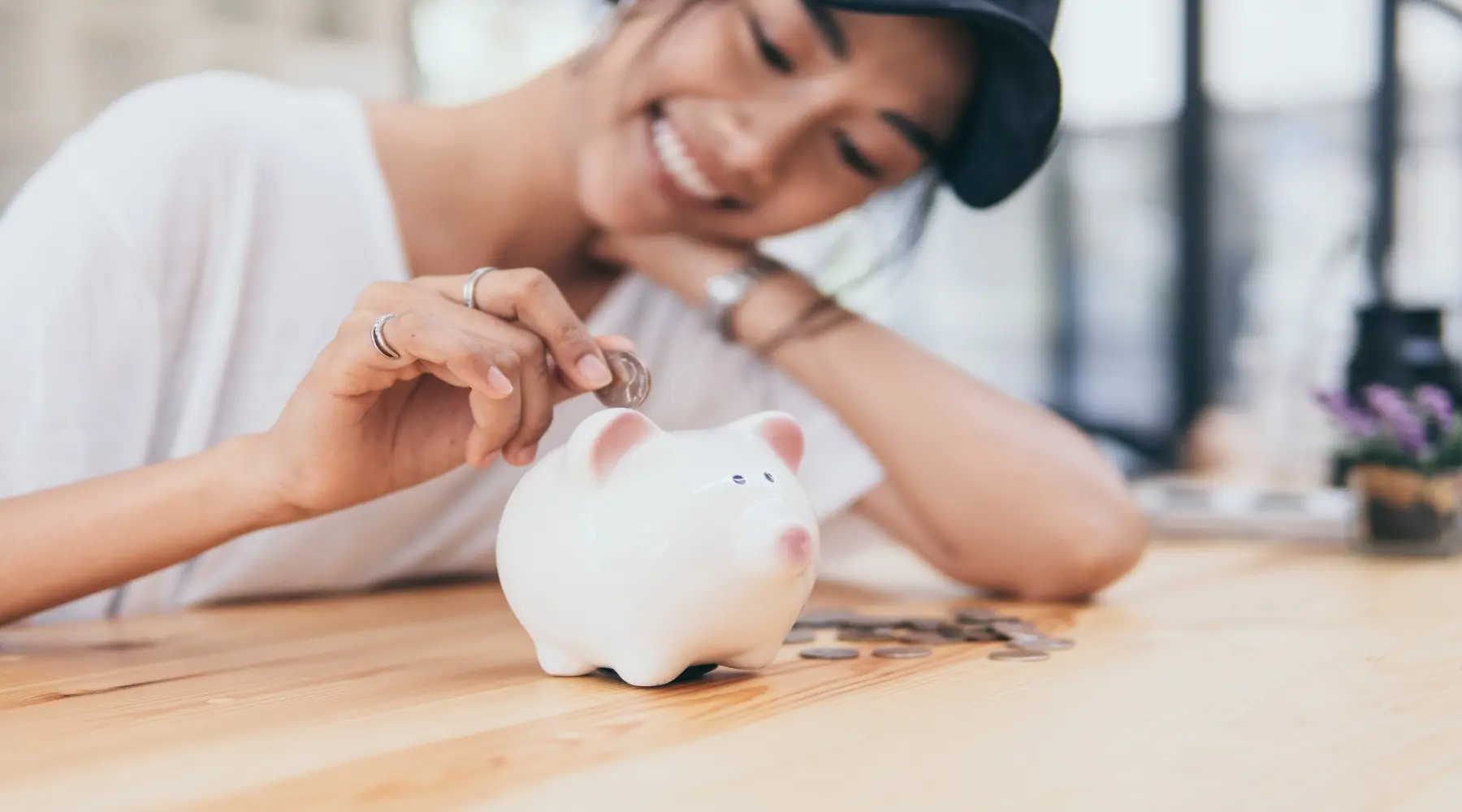 Woman with piggybank_GettyImages_1800x1000
