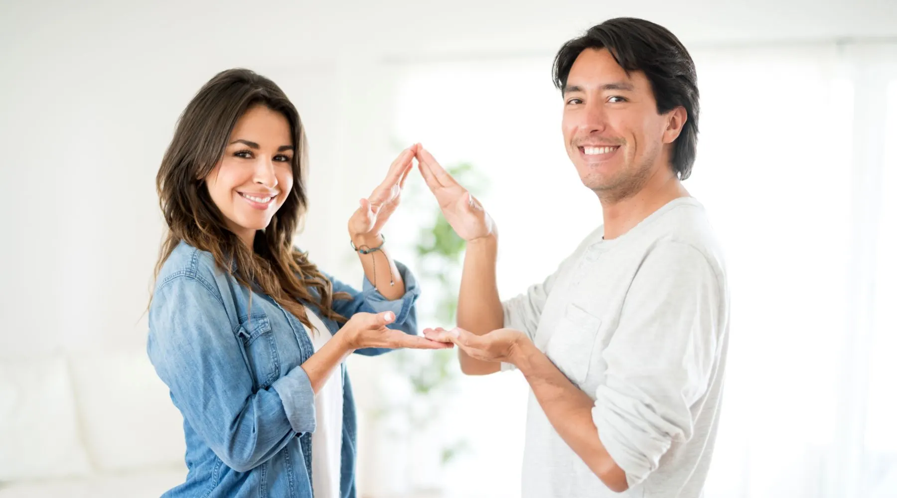 couple with their hands shaped like a house