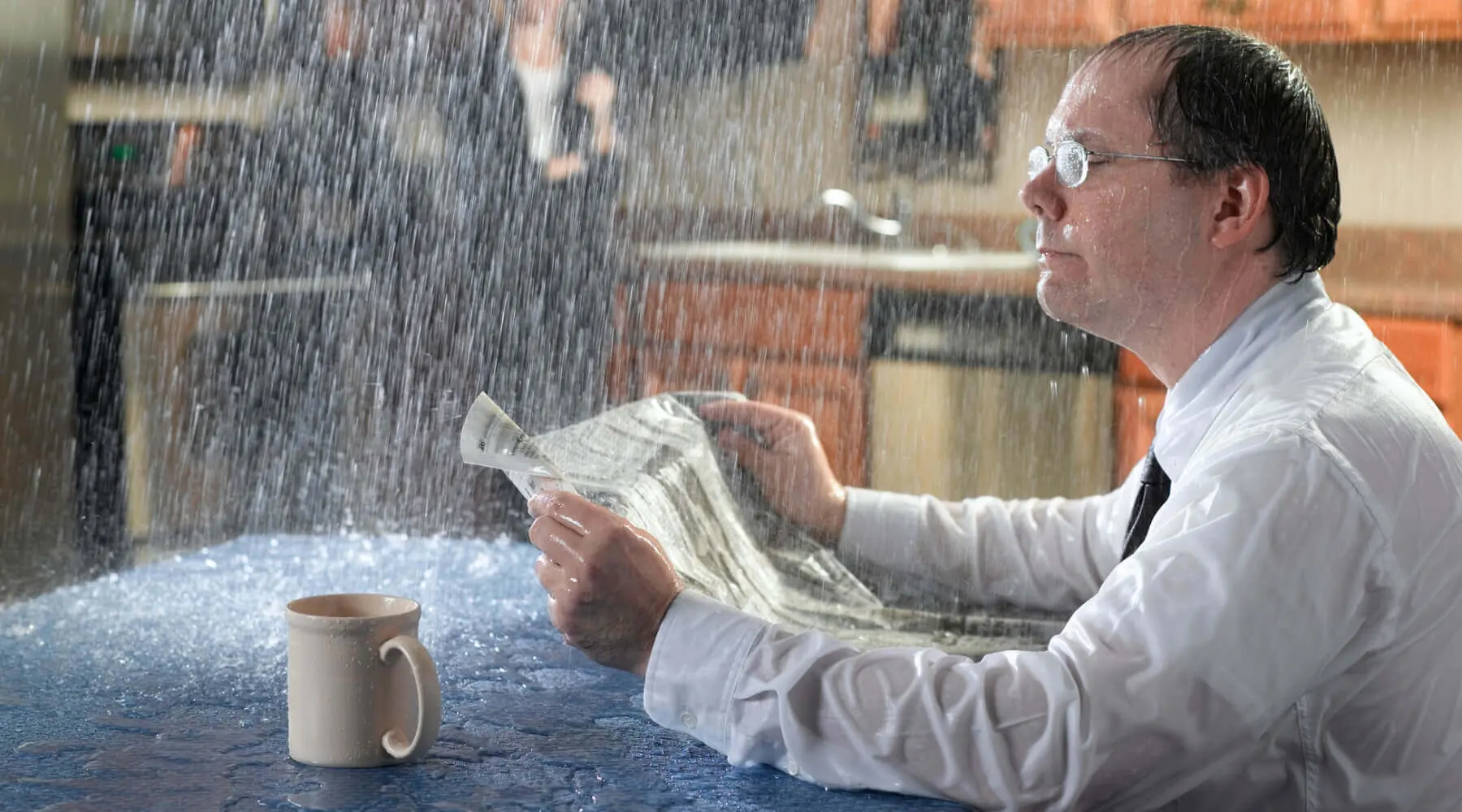 Man reading a newspaper getting rained on inside his home