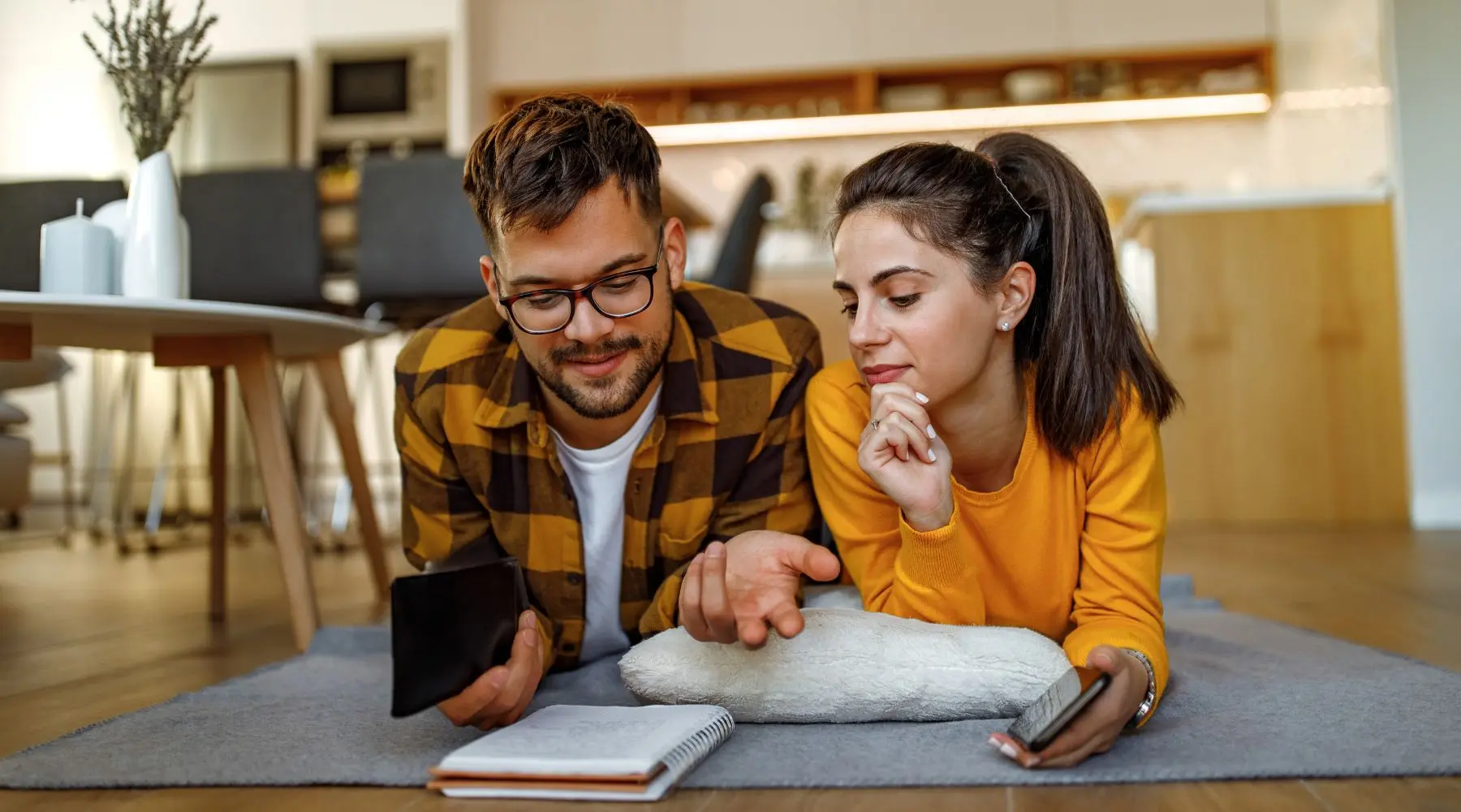 Couple_Reviewing_Finances_On_Floor_Canva_1800x1000