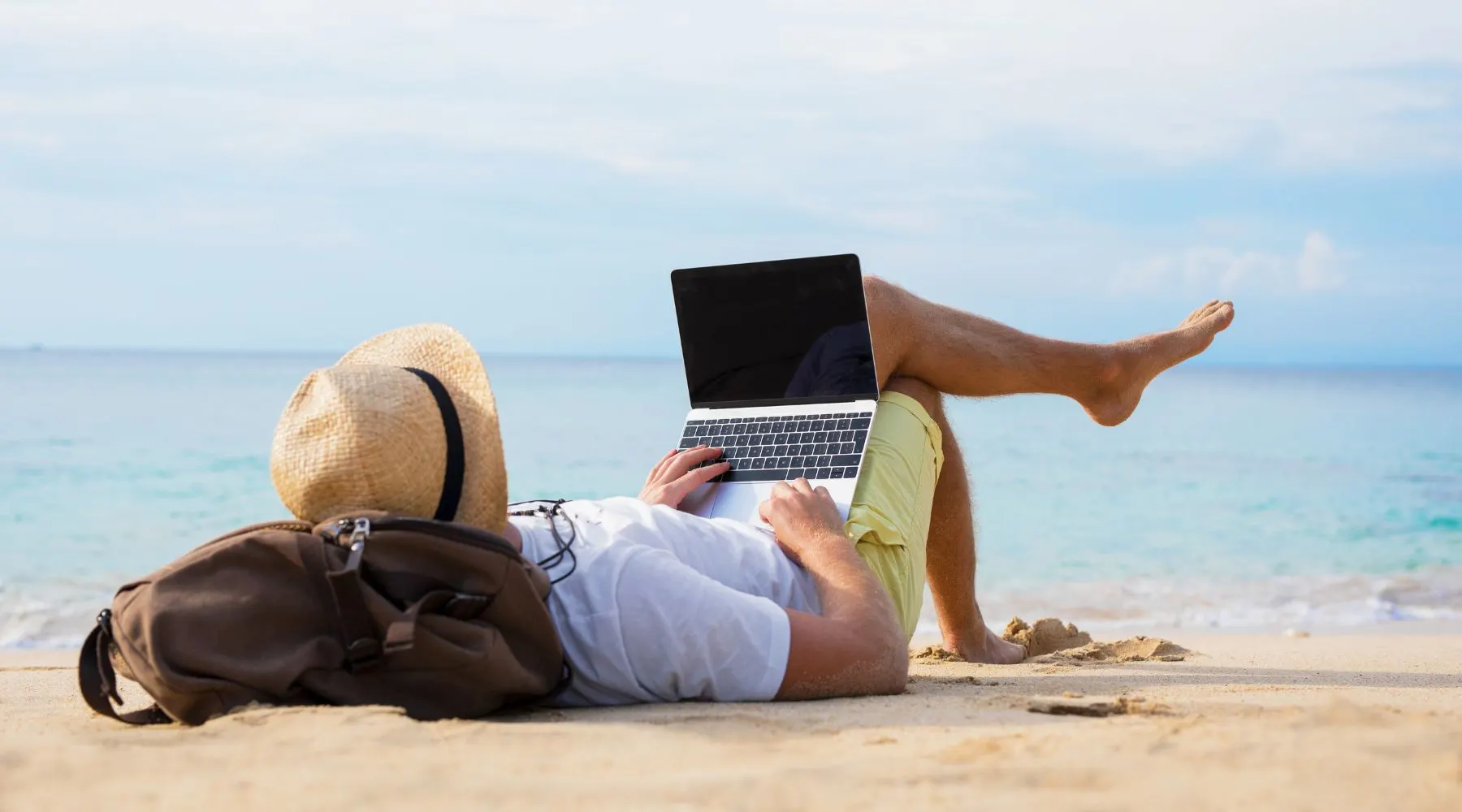 Relaxed Man with Laptop on the Beach