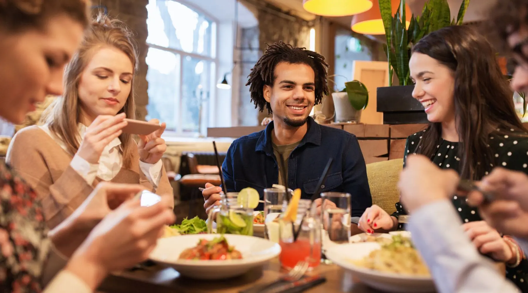 Group_Of_Young_Friends_Dinner_Canva_1800x1000