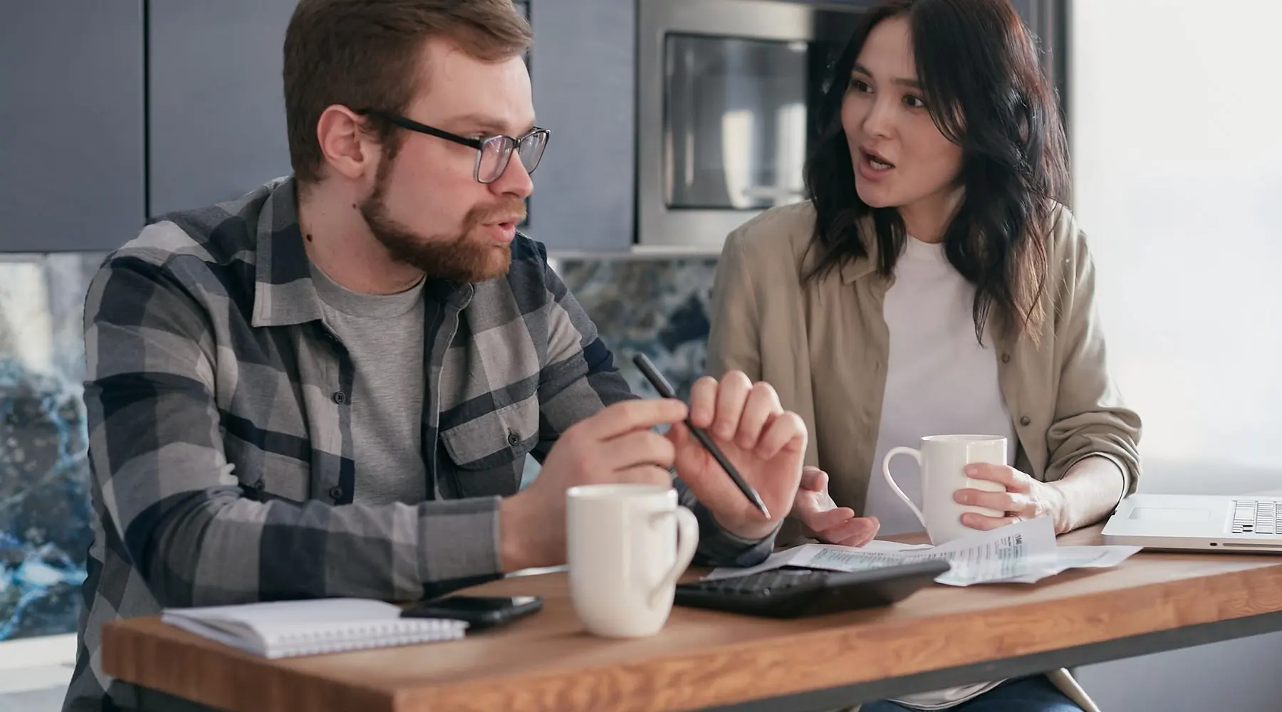 Couple checking finances_Canva_1800x1000