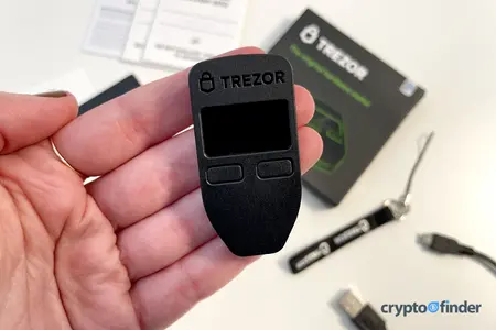 Hand holding a Trezor Model One